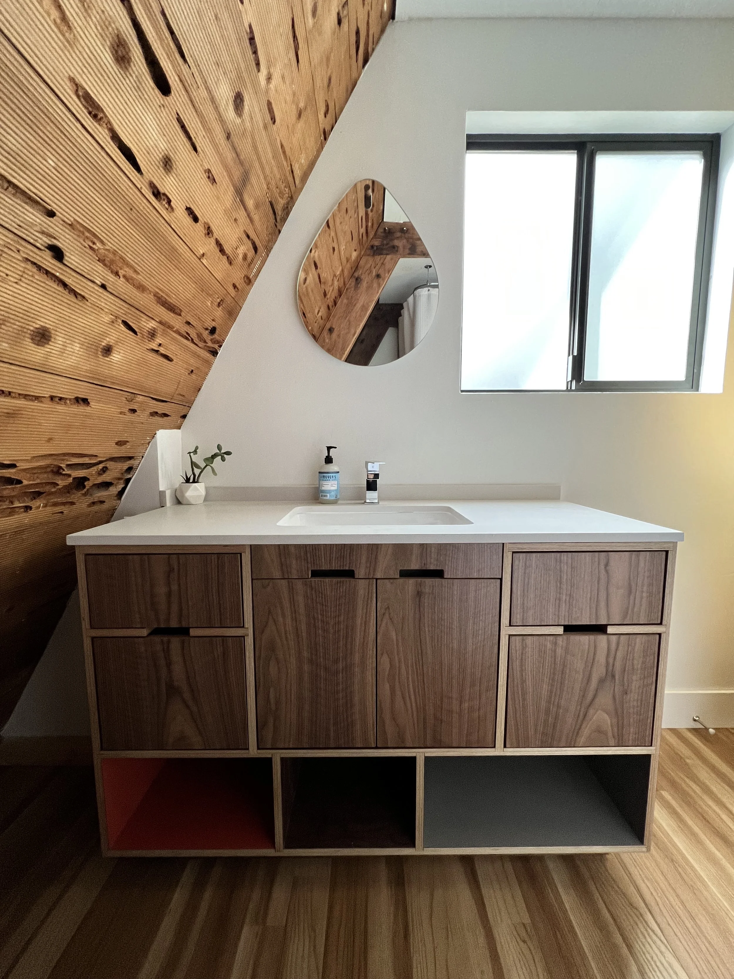 Floating walnut vanity and round mirror