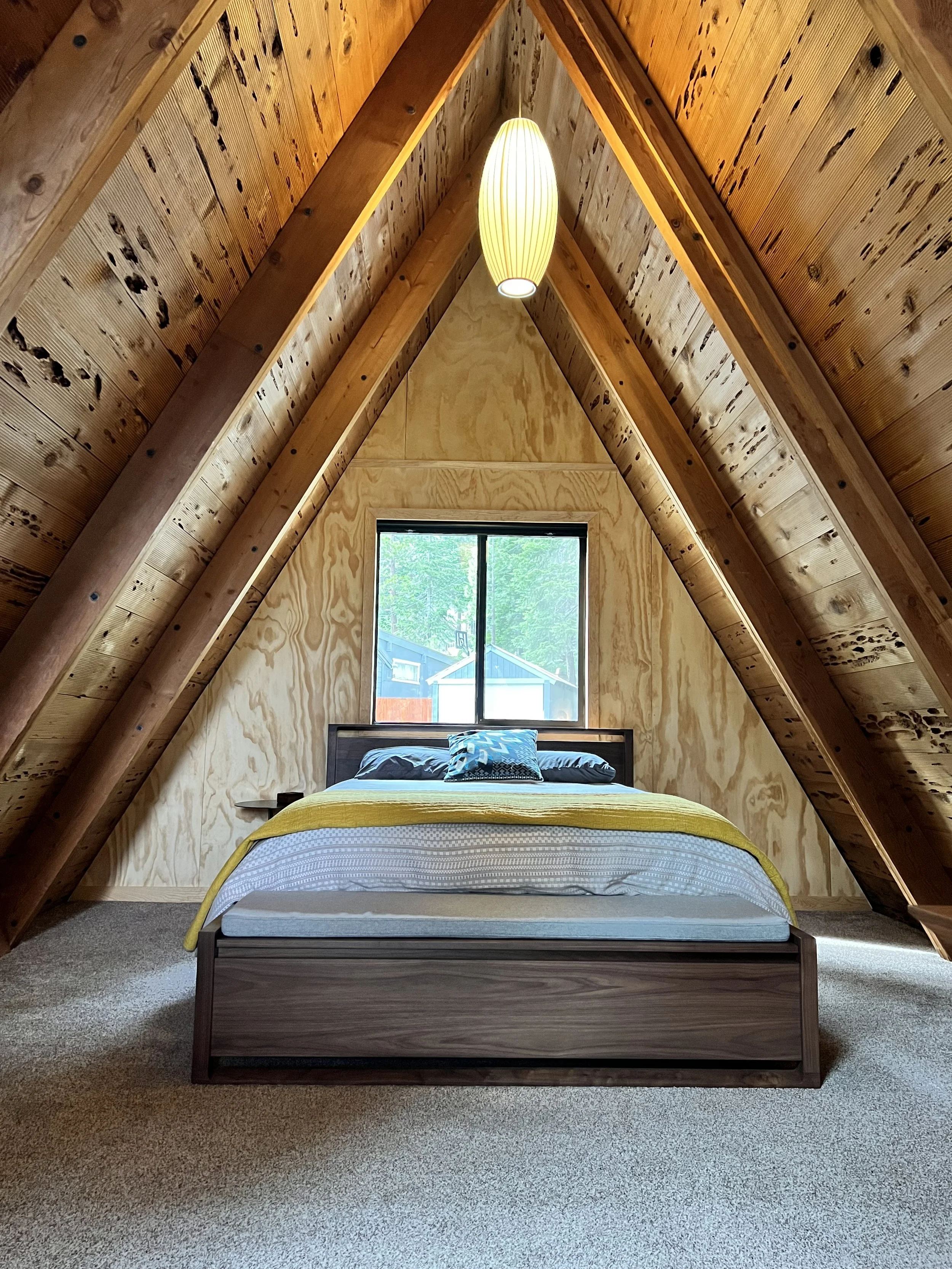 The loft bedroom under the A-Frame ceiling